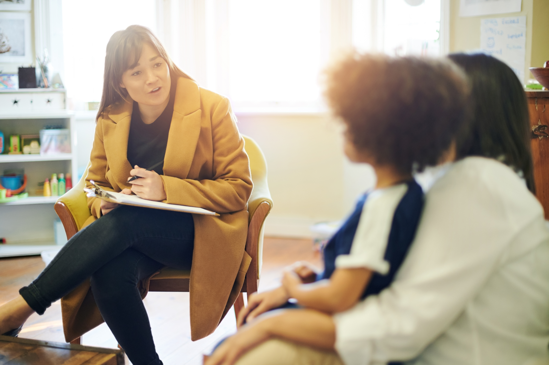 Support, talking and a therapist with a child and parent for discussion about education. Help, therapy and therapist speaking to a kid and mom about helping with mental health and learning disability.